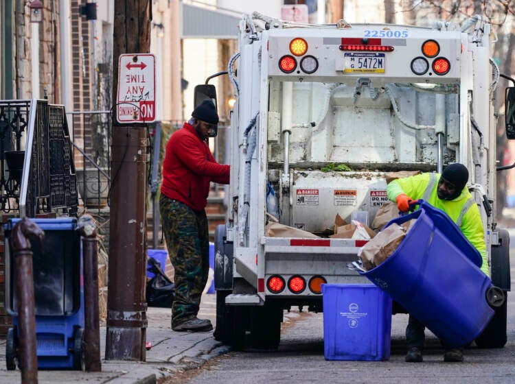 Municipal sanitation workers collect trash in Philadelphia