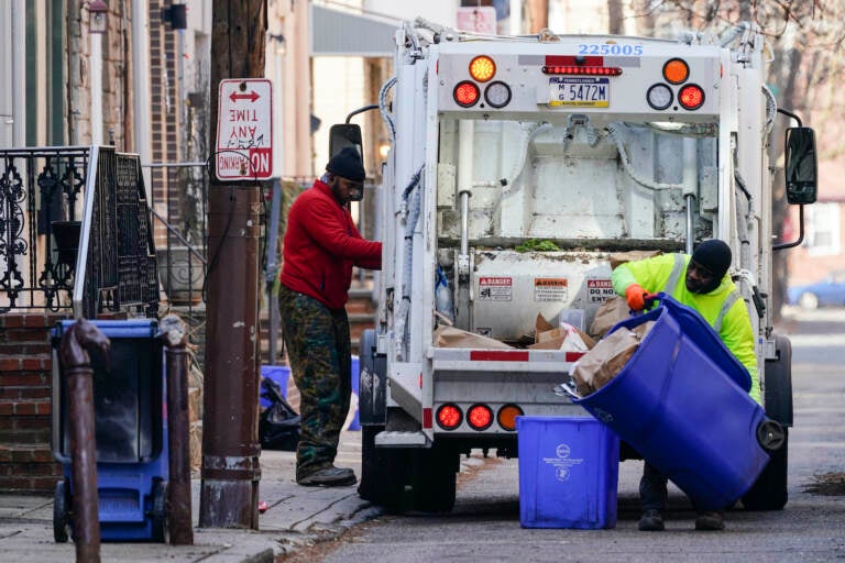 Municipal sanitation workers collect trash in Philadelphia