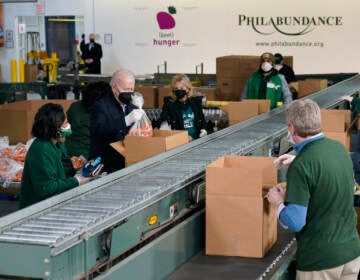 President Joe Biden and first lady Jill Biden pack produce while volunteering at Philabundance