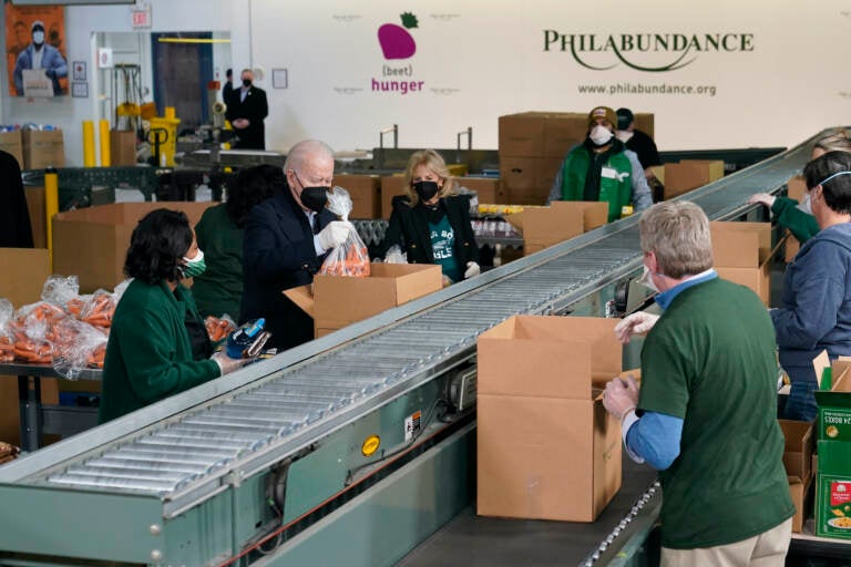 President Joe Biden and first lady Jill Biden pack produce while volunteering at Philabundance