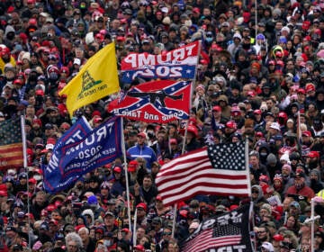 People listen as President Donald Trump speaks during the rally that preceded the insurrection