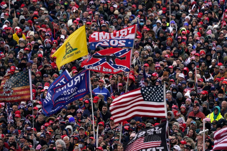 People listen as President Donald Trump speaks during the rally that preceded the insurrection