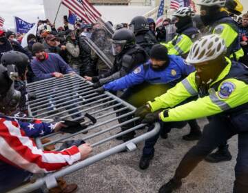 FILE - In this file photo from Wednesday Jan. 6, 2021, Trump supporters beset a police barrier at the Capitol in Washington. (AP Photo/John Minchillo, File)