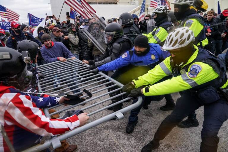 FILE - In this file photo from Wednesday Jan. 6, 2021, Trump supporters beset a police barrier at the Capitol in Washington. (AP Photo/John Minchillo, File)