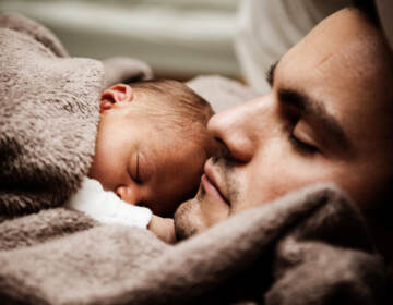 Close up of sleeping man and baby