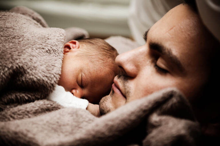 Close up of sleeping man and baby