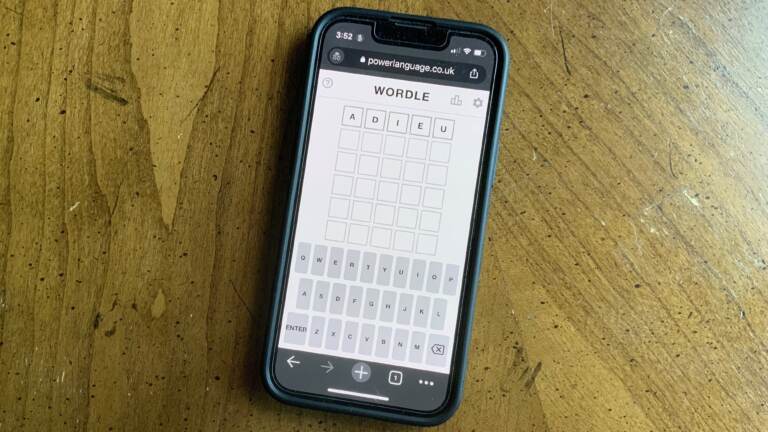A phone screen displays the game ''Wordle''