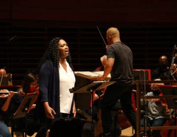 Operatic soprano Angel Blue rehearses with the Philadelphia Orchestra for a performance of ''This Is Not a Small Voice.'' The poem by Sonia Sanchez was put to music by Valerie Coleman. (Emma Lee/WHYY)
