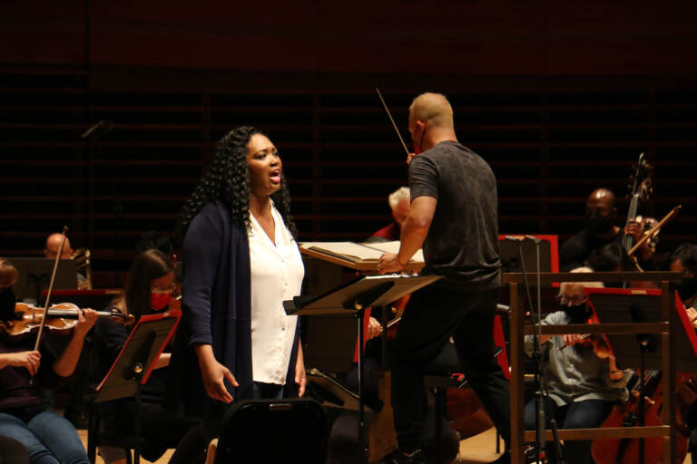 Operatic soprano Angel Blue rehearses with the Philadelphia Orchestra for a performance of ''This Is Not a Small Voice.'' The poem by Sonia Sanchez was put to music by Valerie Coleman. (Emma Lee/WHYY)
