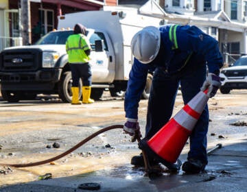 Workers with the Philadelphia Water Department and Philadelphia Gas Works evaluate damage and cap utility lines