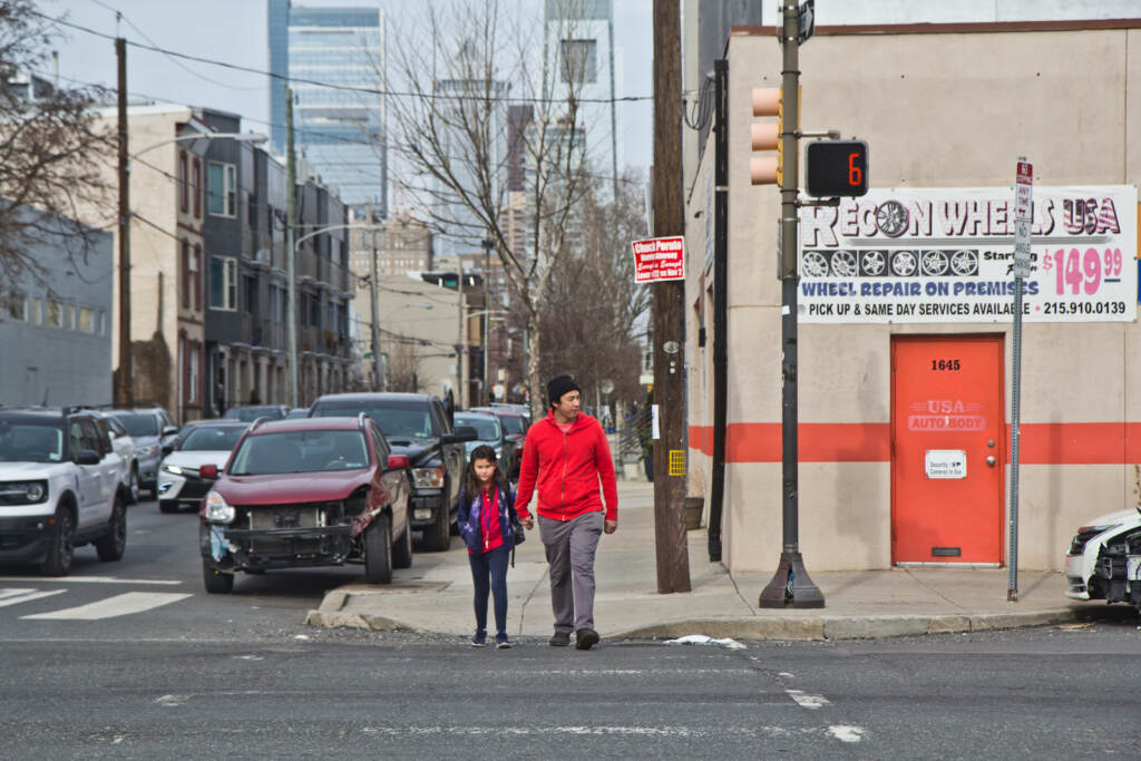 Will Tung and his daughter Juniper cross Washington Avenue.