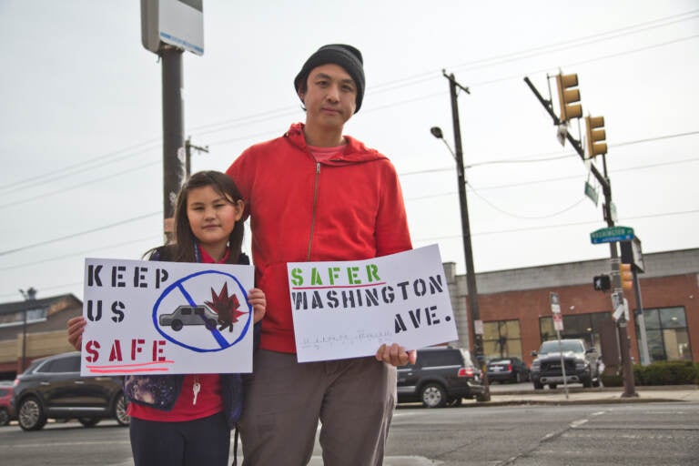 Will Tung and his daughter Juniper hold signs that say 