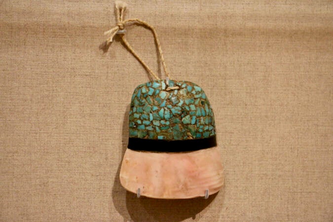 A Zuni Pueblo pendant, circa 1900, is a representation of the Pueblo universe, the sky represented by a mosaic of turquoise stones. (Emma Lee/WHYY)