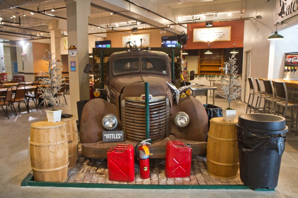 The bed of a vintage truck repurposed as a stage at Vittles food hall