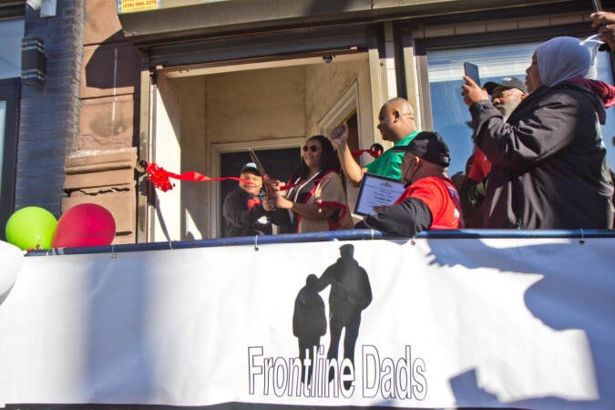 Langston Jones, 11, and his mom Kaphesia Jones, cut the ribbon at the opening of the The Teen Safe Space on North Broad Street in Philadelphia, on February 21, 2022. (Kimberly Paynter/WHYY)