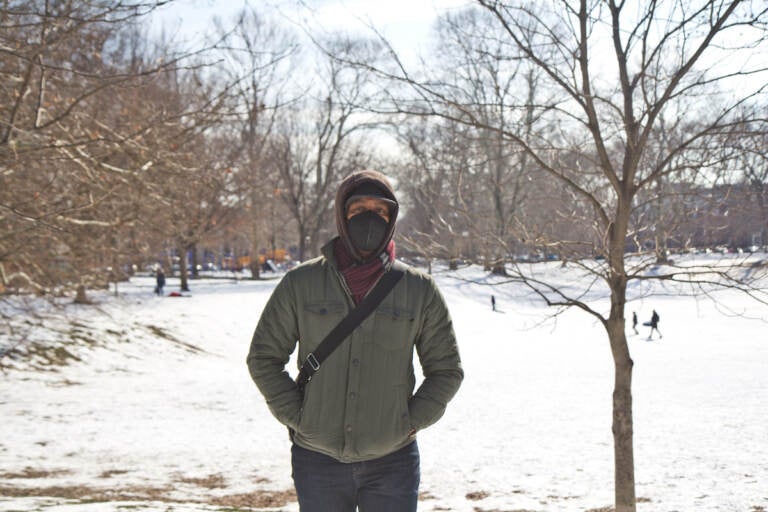 Kermit O stands in Clark Park in the snow