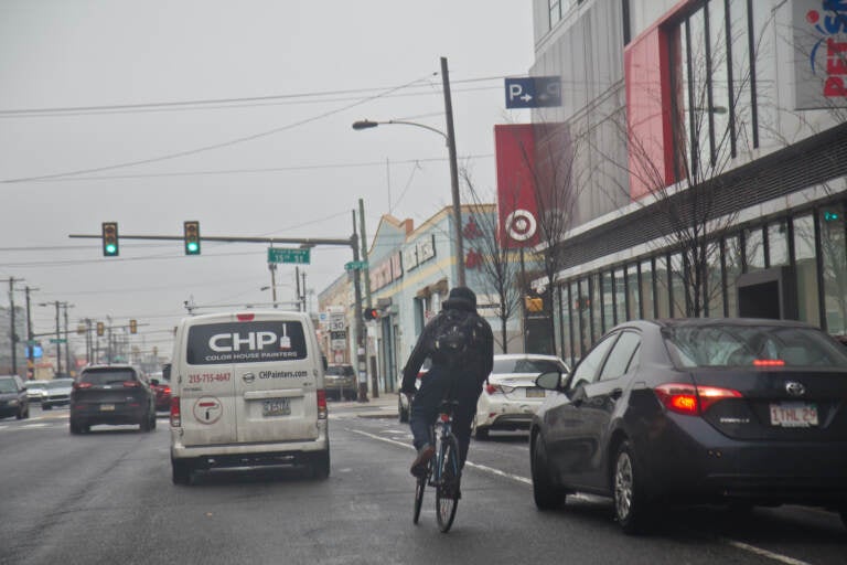 A cyclist rides down Washington Avenue