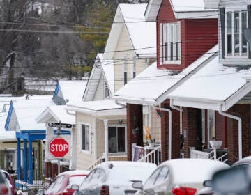 Snow blankets a row of homes after a snowstorm in Bellevue, Ky., on Friday.
Jeff Dean/NPR