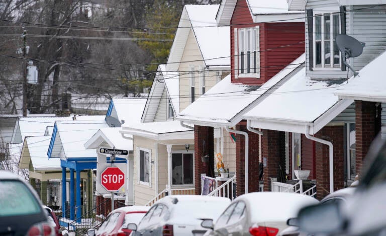 Snow blankets a row of homes after a snowstorm in Bellevue, Ky., on Friday.
Jeff Dean/NPR