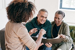 A middle aged couple talking to a financial advisor