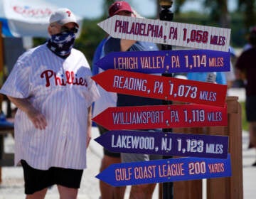 A Philadelphia Phillies fan arrives for a spring training exhibition baseball game between the Phillies and the Toronto Blue Jays in Clearwater, Fla., Tuesday, March 16, 2021. (AP Photo/Gene J. Puskar)