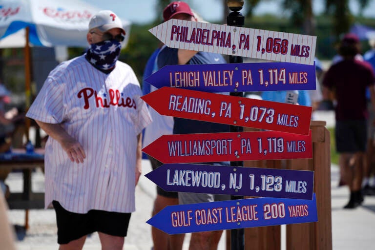 A Philadelphia Phillies fan arrives for a spring training exhibition baseball game between the Phillies and the Toronto Blue Jays in Clearwater, Fla., Tuesday, March 16, 2021. (AP Photo/Gene J. Puskar)