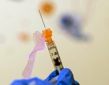 File photo: Nurse Lydia Holly prepares a child's COVID-19 vaccine dose, on Nov. 3, 2021, at Children's National Hospital in Washington. (AP Photo/Carolyn Kaster, File)