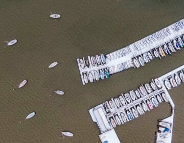 Boats are covered with ice and snow at White Rock Lake, Thursday, Feb. 3, 2022, in Dallas. (AP Photo/Brandon Wade)