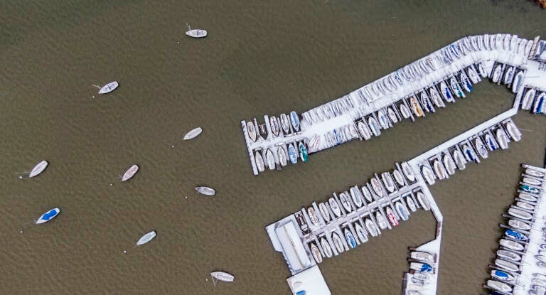 Boats are covered with ice and snow at White Rock Lake, Thursday, Feb. 3, 2022, in Dallas. (AP Photo/Brandon Wade)