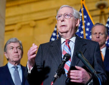 Senate Minority Leader Mitch McConnell of Ky., center, speaks to reporters on Capitol Hill in Washington, Tuesday, Feb. 8, 2022. Standing with McConnell is Sen. Roy Blunt, R-Mo., left, and Sen. John Thune, R-S.D., right