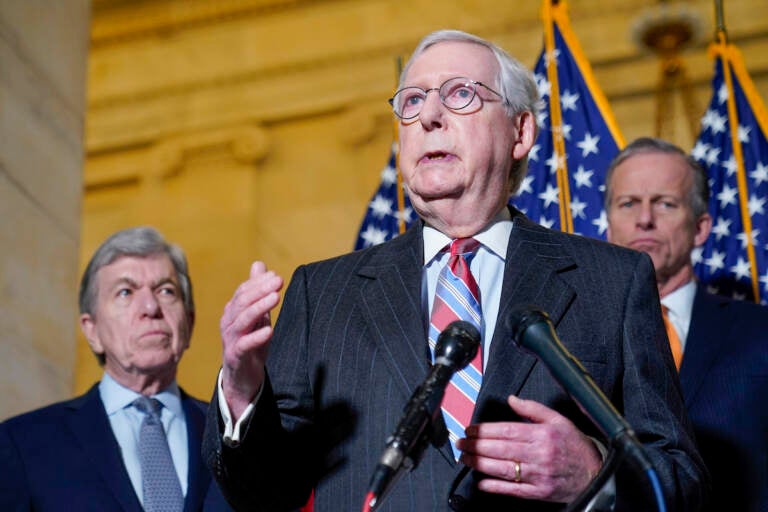 Senate Minority Leader Mitch McConnell of Ky., center, speaks to reporters on Capitol Hill in Washington, Tuesday, Feb. 8, 2022. Standing with McConnell is Sen. Roy Blunt, R-Mo., left, and Sen. John Thune, R-S.D., right