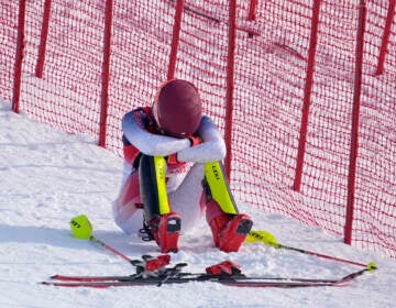 Mikaela Shiffrin, of the United States sits on the side of the course after skiing out in the first run of the women’s slalom at the 2022 Winter Olympics, Wednesday, Feb. 9, 2022, in the Yanqing district of Beijing