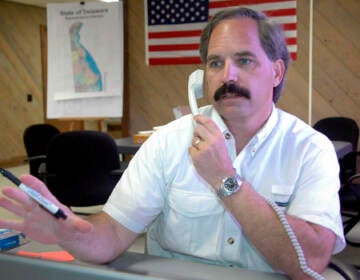 Then-Delaware Republican Senatorial candidate Mike Protack takes a call at his office in Wilmington, Del., on Aug. 14, 2006. The former Delaware political candidate who unsuccessfully sought the Republican nominations for governor and U.S. Senate has been sentenced to a year in prison after pleading guilty to federal charges of mailing threats to a lawyer who represented his wife in a divorce case. Protack was sentenced Tuesday, Feb. 8, 2022 after pleading guilty in August to two counts of mailing a threatening communication. (AP Photo/Pat Crowe II, file)