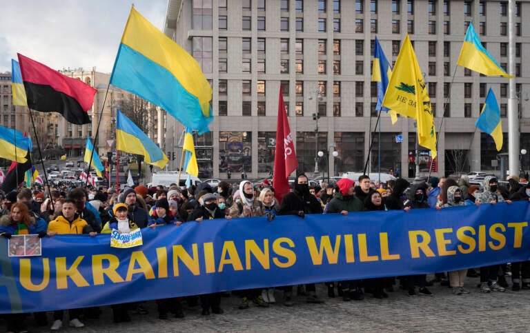 Ukrainians attend a rally in central Kyiv, Ukraine, Saturday, Feb. 12, 2022, during a protest against the potential escalation of the tension between Russia and Ukraine. Russian President Vladimir Putin and U.S. President Joe Biden are to hold a high-stakes telephone call on Saturday as tensions over a possibility imminent invasion of Ukraine escalated sharply and the U.S. announced plans to evacuate its embassy in the Ukrainian capital