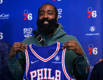 Philadelphia 76ers' James Harden holds up his new jersey after taking questions from the media at a press conference at the NBA basketball team's facility, Tuesday, Feb. 15, 2022, in Camden, N.J. (AP Photo/Chris Szagola)