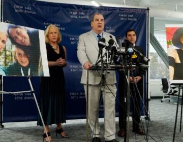 (From left) Randi McGinn, Brian Panish and Jesse Creed, attorneys for the family of the late cinematographer Halyna Hutchins, take part in a news conference alongside portraits of Hutchins and her family, Tuesday, Feb. 15, 2022, in Los Angeles. The family of Hutchins is suing Alec Baldwin and the movie producers of “Rust” for wrongful death, the attorneys said Tuesday