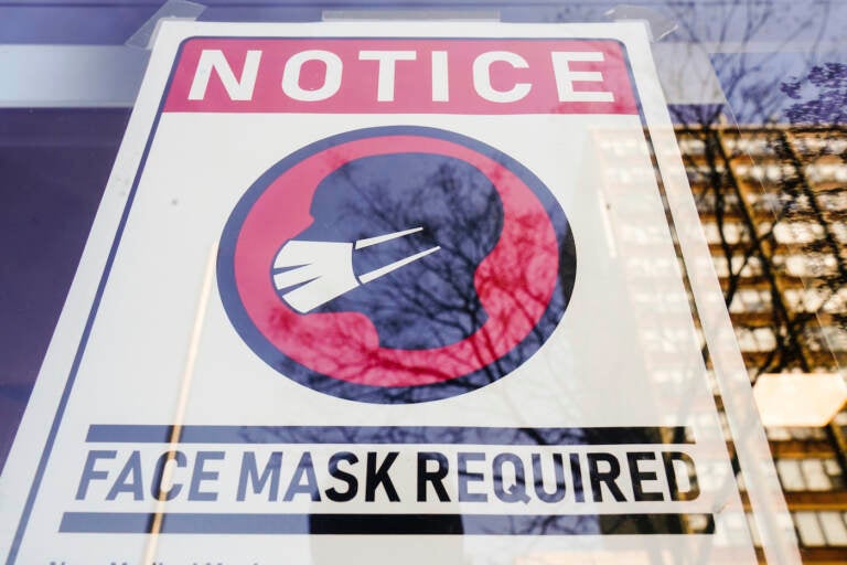A sign requiring masks as a precaution against the spread of the coronavirus