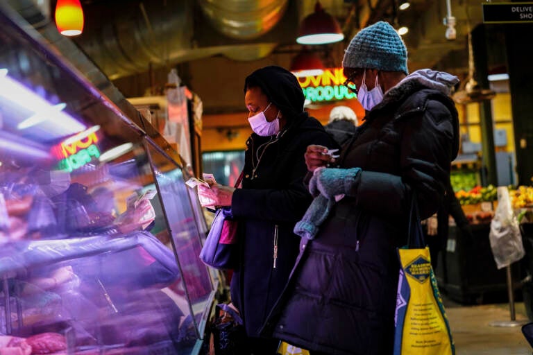 Customers wear face masks while shopping at the Reading Terminal Market