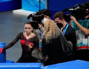 Kamila Valieva, of the Russian Olympic Committee, talks with her coach Eteri Tutberidze after the women's free skate program during the figure skating competition at the 2022 Winter Olympics, Thursday, Feb. 17, 2022, in Beijing