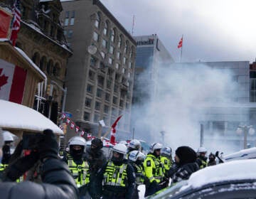Police move in to clear protesters from downtown Ottawa near Parliament hill on Saturday, Feb. 19, 2022. Police resumed pushing back protesters on Saturday after arresting more than 100 and towing away vehicles in Canada’s besieged capital, and scores of trucks left under the pressure, raising authorities’ hopes for an end to the three-week protest against the country’s COVID-19 restrictions