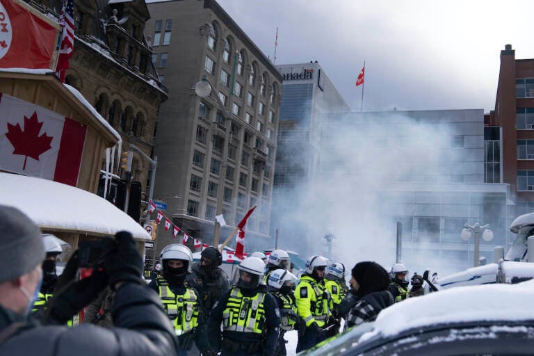 Police move in to clear protesters from downtown Ottawa near Parliament hill on Saturday, Feb. 19, 2022. Police resumed pushing back protesters on Saturday after arresting more than 100 and towing away vehicles in Canada’s besieged capital, and scores of trucks left under the pressure, raising authorities’ hopes for an end to the three-week protest against the country’s COVID-19 restrictions