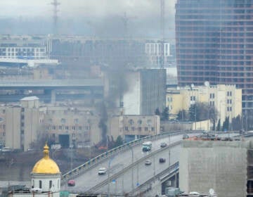 Smoke and flame rise near a military building after an apparent Russian strike in Kyiv, Ukraine, Thursday, Feb. 24, 2022. Russian troops have launched their anticipated attack on Ukraine. Big explosions were heard before dawn in Kyiv, Kharkiv and Odesa as world leaders decried the start of an Russian invasion that could cause massive casualties and topple Ukraine's democratically elected government