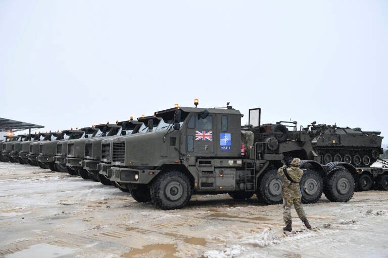 Tanks uploaded on military truck platforms as a part of additional British troops and military equipment arrive at Estonia's NATO Battle Group base in Tapa, Estonia, Friday, Feb. 25, 2022. With Ukrainian President Volodymyr Zelenskyy appealing for help, NATO members ranging from Russia’s neighbor Estonia in the north down to Bulgaria on the Black Sea coast triggered urgent consultations about their security