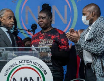 Rev. Al Sharpton, left, president of the National Action Network (NAN), and Mayor Eric Adams, right, stand next to Sybrina Fulton, center, the mother of Trayvon Martin, as she address a rally commemorating the 10th anniversary of her son’s killing, Saturday Feb. 26, 2022, at NAN’s Harlem headquarters in New York. “Today is a bittersweet day,” said Fulton, who with her family created the Trayvon Martin Foundation to raise awareness of gun violence