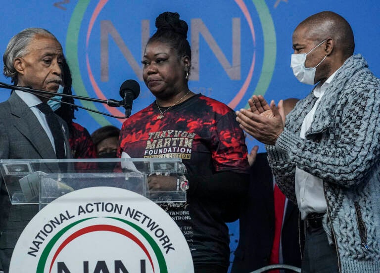 Rev. Al Sharpton, left, president of the National Action Network (NAN), and Mayor Eric Adams, right, stand next to Sybrina Fulton, center, the mother of Trayvon Martin, as she address a rally commemorating the 10th anniversary of her son’s killing, Saturday Feb. 26, 2022, at NAN’s Harlem headquarters in New York. “Today is a bittersweet day,” said Fulton, who with her family created the Trayvon Martin Foundation to raise awareness of gun violence