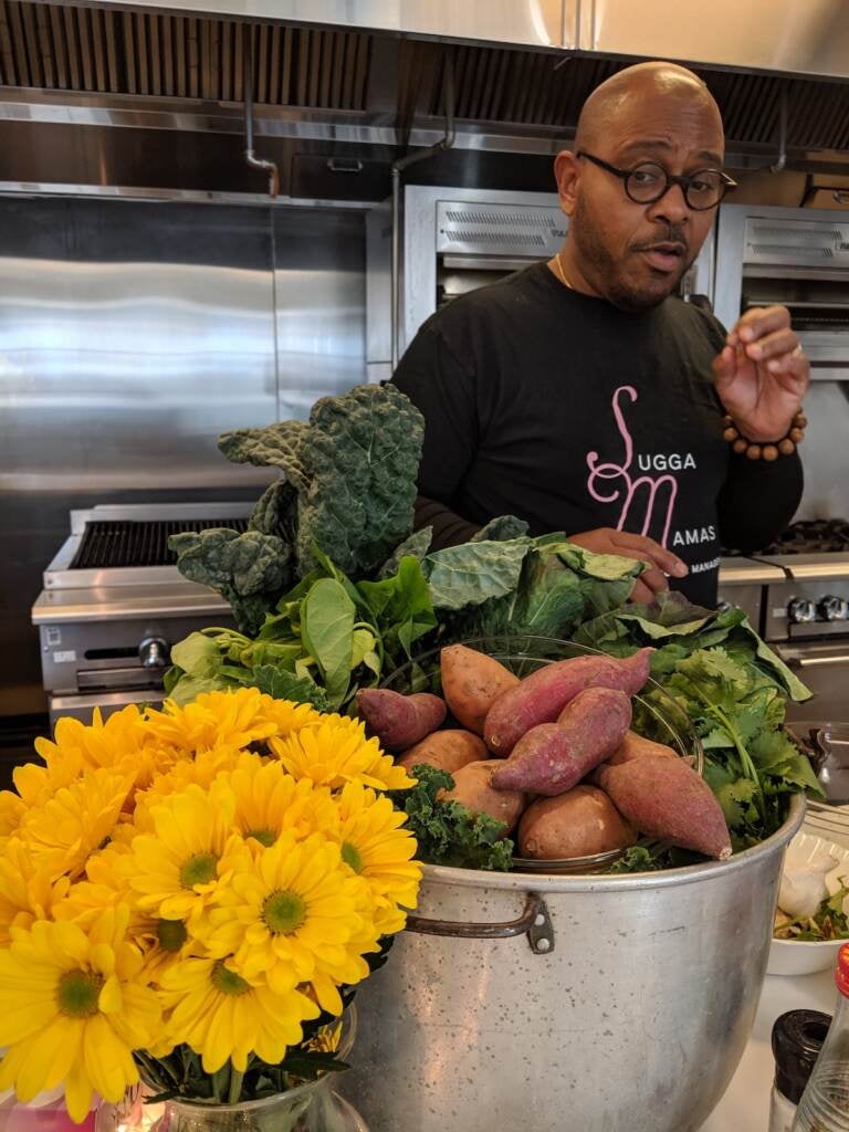 Chef Yuhnis Sydnor in the Culinary Literacy Center kitchen with his grandmother's pot which she used for cleaning chitlins. (Photo courtesy of Culinary Literacy Center)