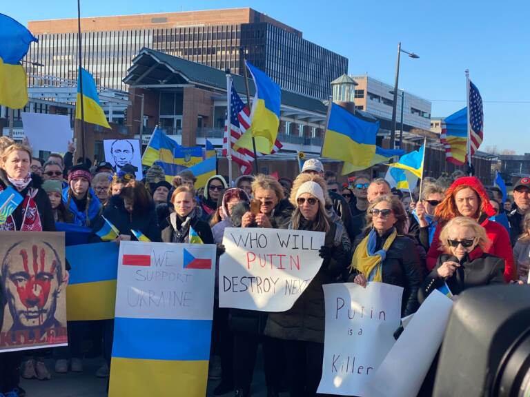 People hold up signs in support of Ukraine at a rally in Philly