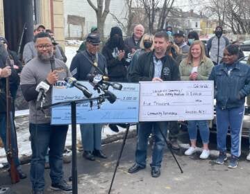 Representatives from the Amazon Black Employees Network based at hubs in Deptford and Florence present checks totaling $10,000 towards the restoration of Locust Hill Cemetery in Trenton. There will also be a Black history museum constructed on the site as well