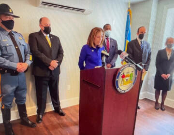 Attorney General Kathy Jennings (at microphone) says straw purchases are a prevalent menace. (State of Delaware)