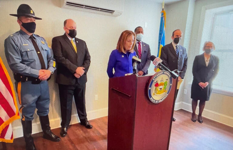 Attorney General Kathy Jennings (at microphone) says straw purchases are a prevalent menace. (State of Delaware)